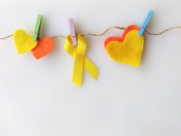 Yellow ribbon, hearts, pinned to clothesline
