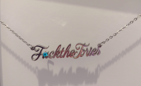 Necklace on a white background saying "F*ck The Tories"