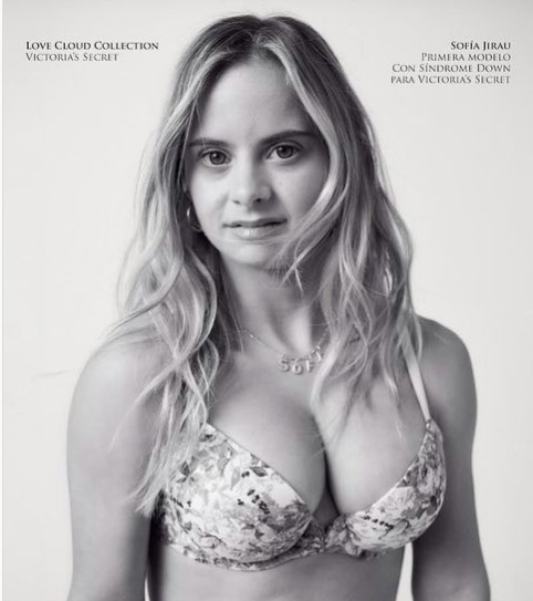 Victoria's Secret model Sofia Jirau - a feminine presenting person with down's syndrome and long blonde hair- she is wearing just a pretty bra and looking in to camera