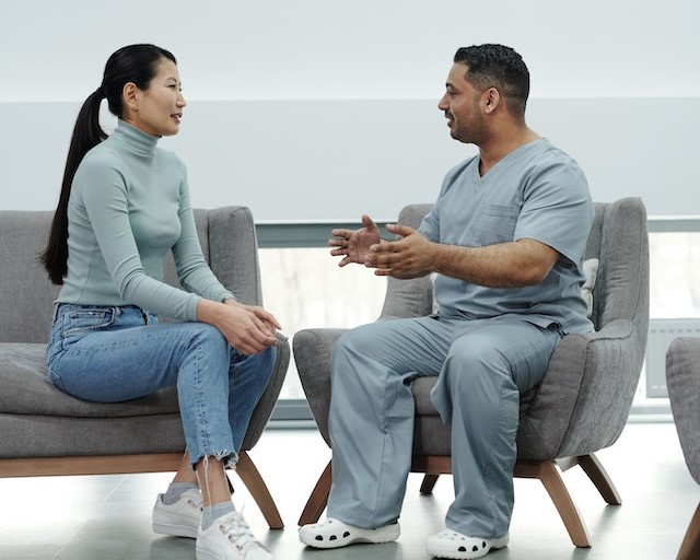 Female presenting patient having a conversation with a doctor (male presenting)