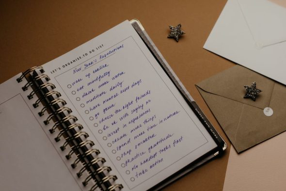 a notebook open with a list of new years resolutions
